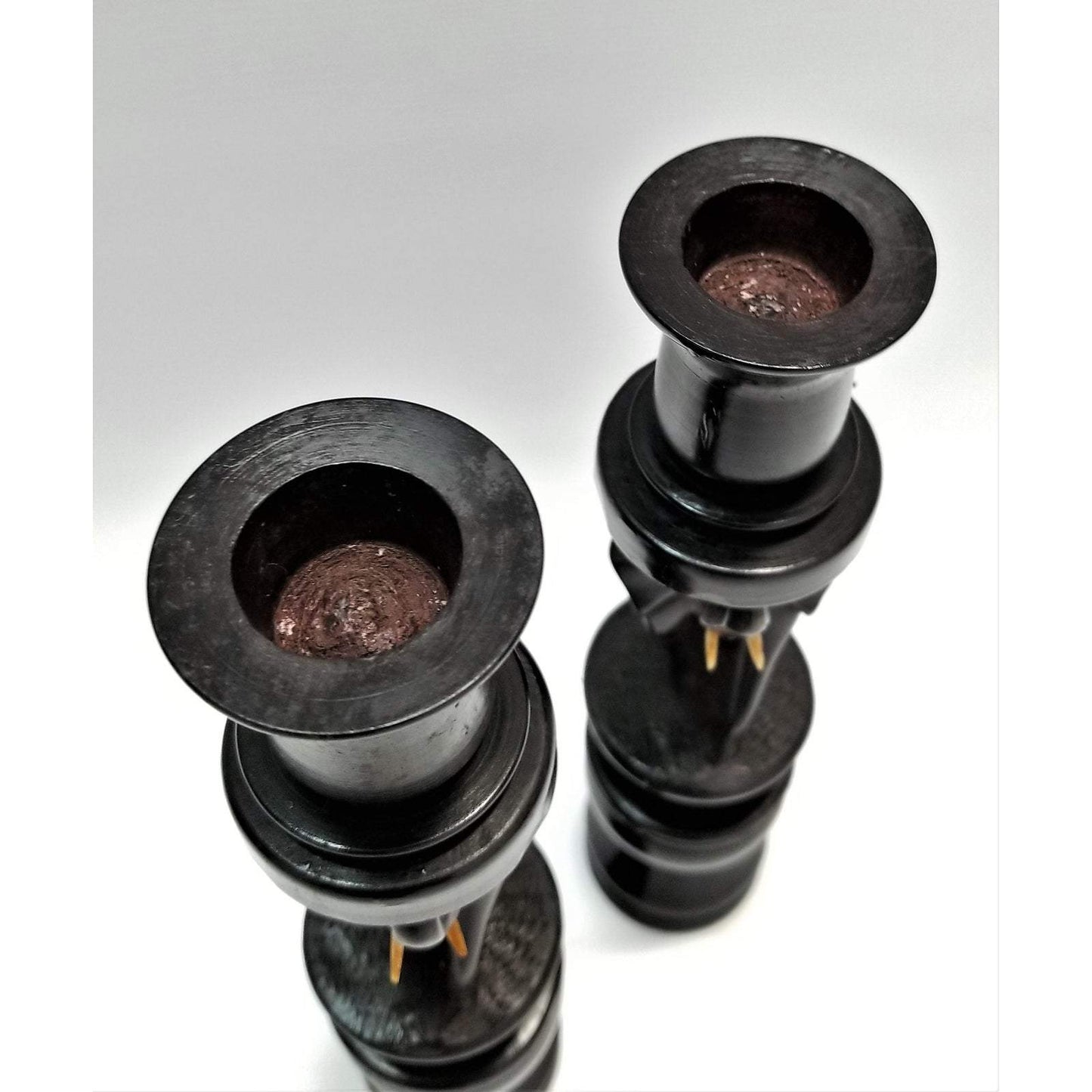 A pair of Elephant Curved Ebony Candle Holders